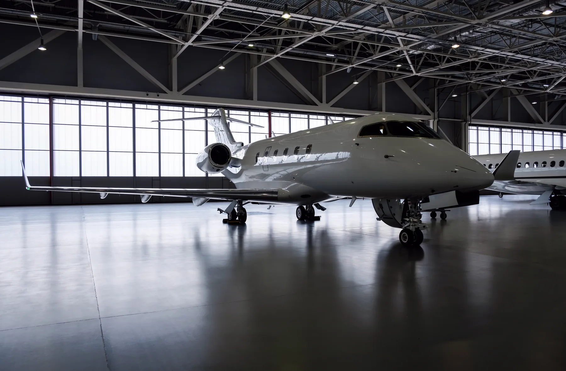 Business jet in a dark hangar, Pulse Aviation maintenance facility at KLAL