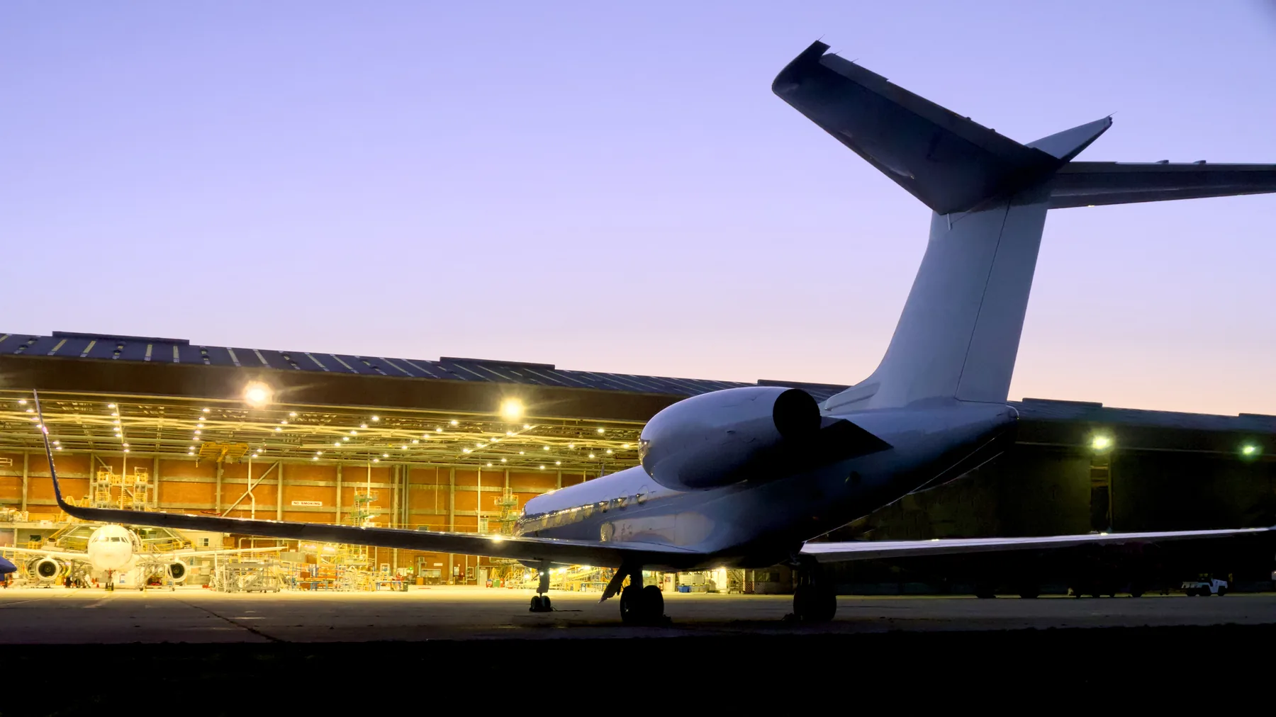 Business jet under hangar lights, AOG response